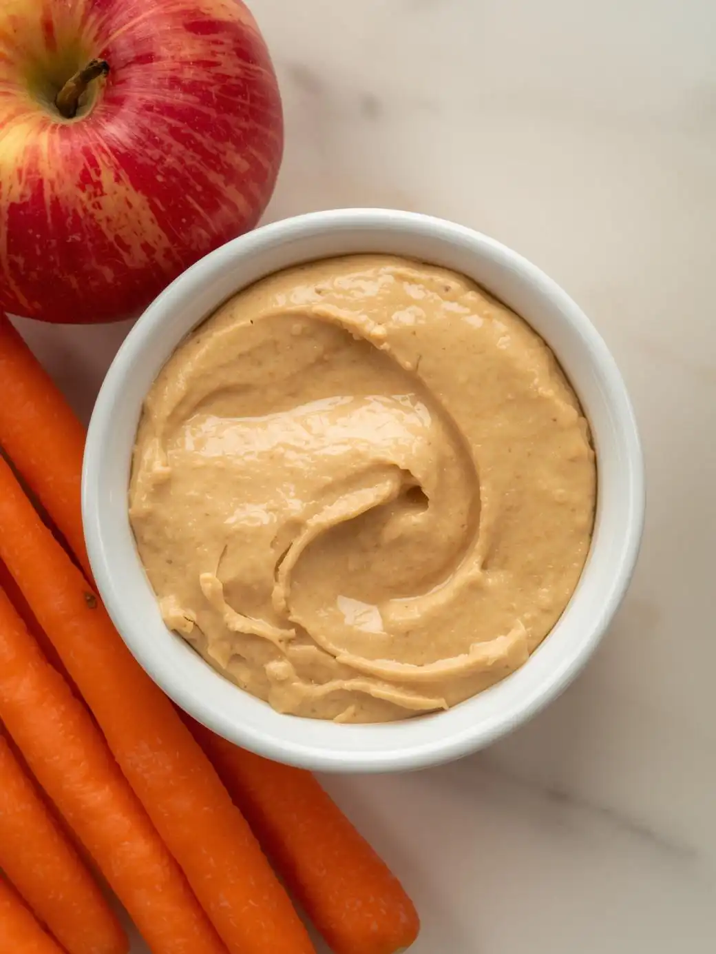 Baby carrots with unsalted hummus or an apple.